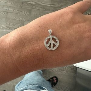 White gold diamond peace sign pendant
14k